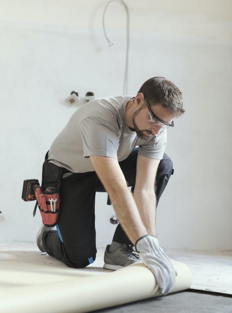 contractor-removing-an-old-linoleum-flooring. carpet repair expert